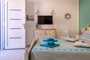 a bedroom with a bed with a teddy bear on it at Affittacamere LiKele in Castelsardo