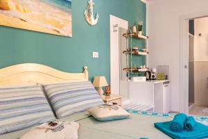 a bedroom with a bed with towels on it at Affittacamere LiKele in Castelsardo +17 photos