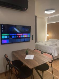 a room with a table and a bed and a tv at Philoxenia by nature in Karkaloú