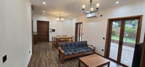 a living room with a couch and a table at Moradia Pérola da Natureza in Lemos