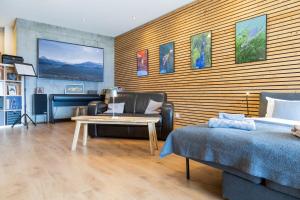 a living room with a couch and a table at Chalet Diognysos B&B, Wellness & Boutique Hotel, Valais Crans-Montana Diogne in Crans-Montana