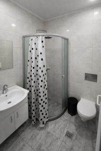 a bathroom with a shower and a sink and a toilet at dupleqs batumi daRia in Angisa +10 photos