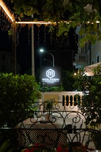 a sign that is lit up at night at Hotel Touring Wellness & Beauty in Fiuggi +68 photos
