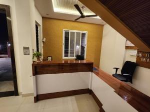 a lobby with a staircase with a ceiling fan at Omisha Stay & Pavilion in Sehore