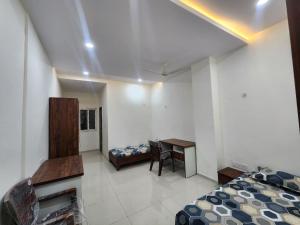 a bedroom with a bed and a desk and a table at Omisha Stay & Pavilion in Sehore