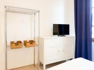 a bedroom with a mirror and a tv on a dresser at Ponticello Mare - HelloElba in Portoferraio