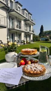 a table with three pies and apples on it at Gästehaus Brangshof in Willich