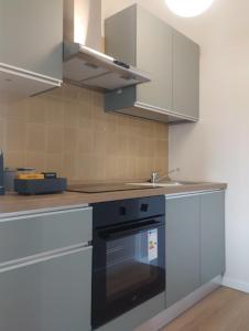 a kitchen with a sink and a stove top oven at Residenze Venezia Apartments in Mestre