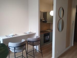 a kitchen with a table and two stools at Residenze Venezia Apartments in Mestre +45 photos