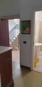 a hallway with a door leading into a room with stairs at vacanza in appartamento sul mare in Fano +11 photos