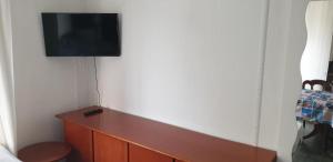 a living room with a tv on a wall at vacanza in appartamento sul mare in Fano