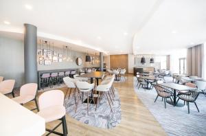 a restaurant with tables and chairs in a room at Hampton By Hilton Blackpool in Blackpool +65 photos