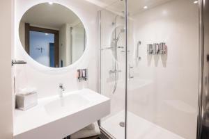 a bathroom with a sink and a shower at Hampton By Hilton Blackpool in Blackpool