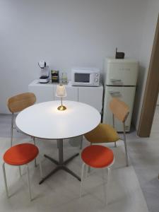 a white table with four chairs and a microwave at K Hubhouse - Taereung stn 5min walk#villa 4pax in Seoul