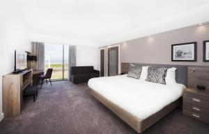 a hotel room with a large bed and a desk at Hampton By Hilton Blackpool in Blackpool