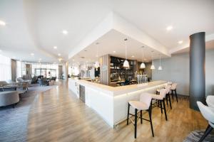 a restaurant with a bar with stools at Hampton By Hilton Blackpool in Blackpool