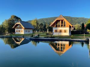 a house with a reflection in the water at Ebner 1822 in Gnesau