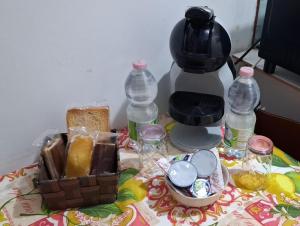 a table topped with bottles of water and a coffee maker at Elico A WITH PRIVET JAKUZI in Sambuca di Sicilia