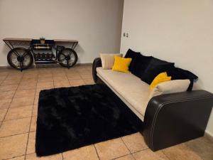 a living room with a couch and a carriage at Holiday Apartman in Kecskemét +20 photos