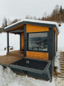 a tiny house on a deck in the snow at Putyscha house in Tukhlya