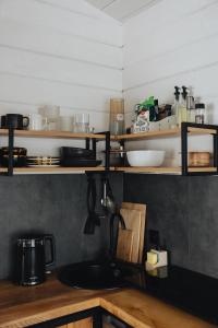 a kitchen with wooden shelves and a sink at Putyscha house in Tukhlya