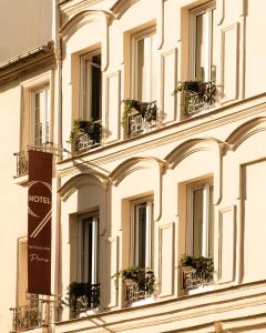 a building with windows and potted plants on it at 9Hotel Bastille-Lyon in Paris