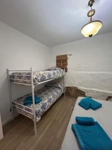 a room with two bunk beds and a table at Almodovar alojamientos 1 in Almodóvar del Río +9 photos