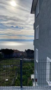 a building with a fence in front of a field at Kuğu Apart Pansiyon in Sinop