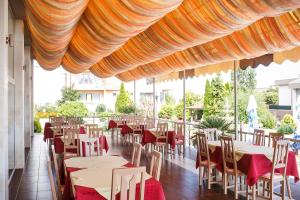 a restaurant with tables and chairs under a tent at Hotel Fiesta in Golden Sands