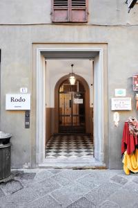 a doorway to a building with a door with a sign at Numa Florence Rodo in Florence