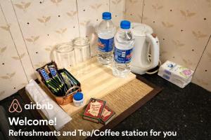 a counter with two bottles of water and a coffee maker at G studio in Guruvāyūr