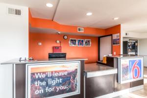 a fast food restaurant with an orange wall at Motel 6-San Antonio, TX - South WW White Rd in San Antonio