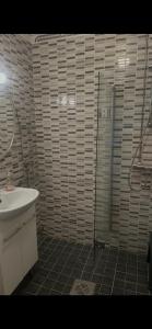 a bathroom with a shower and a sink at Martan Porti Three-bedroom house in Imatra +13 photos