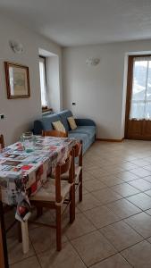 a living room with a table and a couch at Sambor apartment in Oga +15 photos
