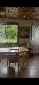 a dining room with a table and chairs and a window at Martan Porti Three-bedroom house in Imatra