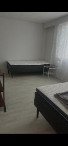 a room with a bed and a bench in it at Martan Porti Three-bedroom house in Imatra