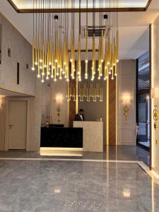 a lobby with chandeliers and a man in the background at Elysia Plus Hotel in Istanbul