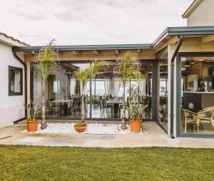 a home with palm trees on a patio at 266 La Barraca in Torvaianica