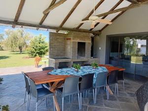 a patio with a table and chairs and a fireplace at Vaal Dam Manor - Waters Edge in Oranjeville