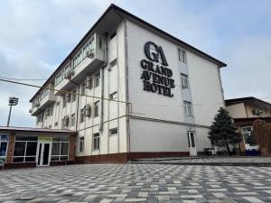 a building with a sign on the side of it at Avenue Hotel Tashkent in Tashkent