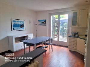 a kitchen and dining room with a table and a dining room at host di Elena in Lesmo