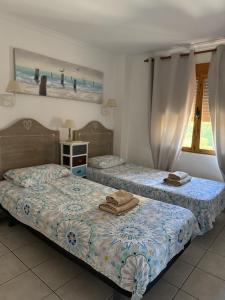 two beds in a room with two beds sidx sidx sidx sidx at Bungavilla House in La Isla in Jávea +61 photos