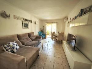 a living room with a couch and a fireplace at Bungavilla House in La Isla in Jávea