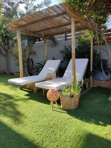 a gazebo with two beds in a yard at Harmony garden house in Porto Rafti