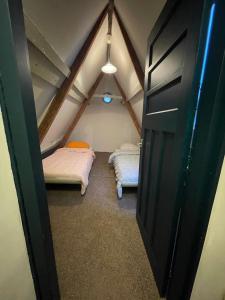 a small room with two beds in a attic at Appartement city center in Harlingen