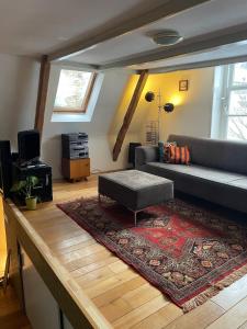 a living room with a couch and a rug at Appartement city center in Harlingen