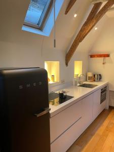 a kitchen with a black refrigerator in a room at Appartement city center in Harlingen