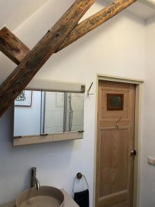 a bathroom with a sink and a mirror at Appartement city center in Harlingen