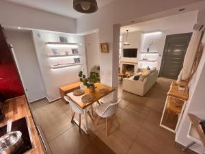 a living room with a table and a couch at Harmony garden house in Porto Rafti