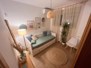 a small room with a bed and a chair at Harmony garden house in Porto Rafti